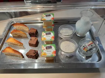 a tray of food with bread and milk on it at Fasthotel Narbonne in Narbonne