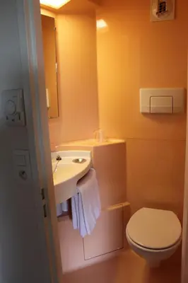 a bathroom with a sink and a toilet at Hôtel Premiere Classe Pamiers in Pamiers