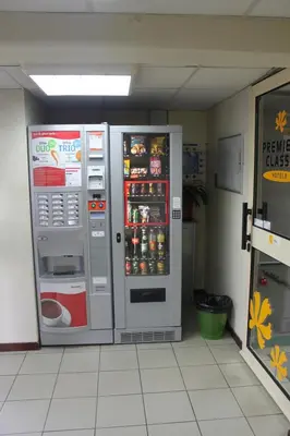 two refrigerators are sitting in a room at Hôtel Premiere Classe Pamiers in Pamiers