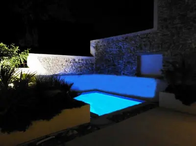 a swimming pool in a yard at night at L'Accent d'ici in Le Somail