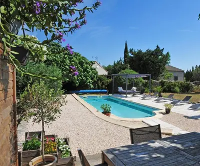 a swimming pool in a yard with chairs around it at Gîte Madeleine in Saint-Nazaire-dʼAude