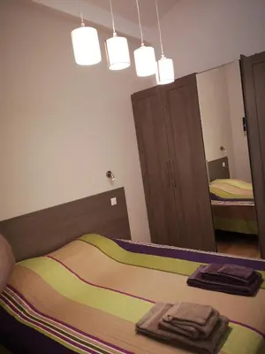a bedroom with a bed and a large mirror at Gîte Madeleine in Saint-Nazaire-dʼAude