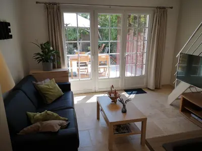 a living room with a couch and a coffee table at Gîte Madeleine in Saint-Nazaire-dʼAude