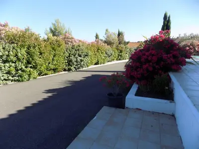 a street with flowers on the side of a wall at Villa VAYA in Villemoustaussou