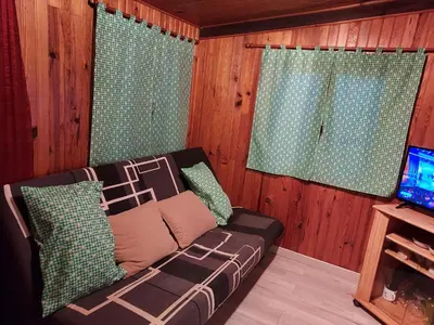 a living room with a couch and a television at camping le pavillon in Sigean
