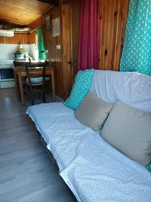 a couch in a living room with a table at camping le pavillon in Sigean