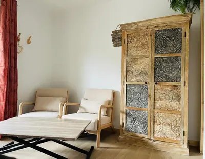 a room with two chairs and a wooden cabinet at Caprice Gruissanais Spa - T2 plage des chalets in Gruissan