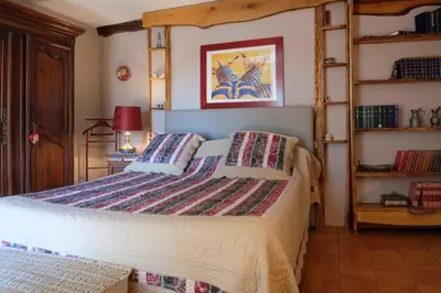 a bedroom with a bed with a ladder at Domaine de Malouziès in Fontiers-Cabardès