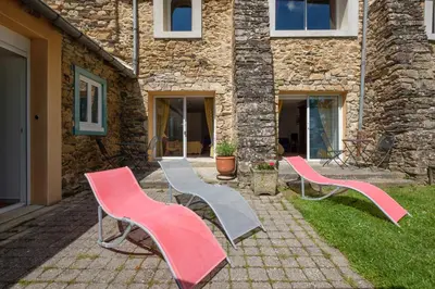 a group of chairs sitting in front of a building at Domaine de Malouziès in Fontiers-Cabardès