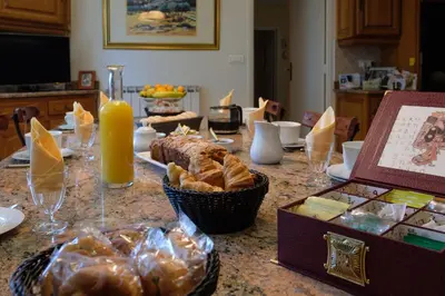 a table topped with bread and a box of orange juice at Domaine de Malouziès in Fontiers-Cabardès