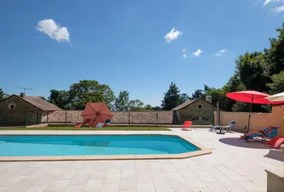 a swimming pool with chairs and umbrellas in a yard at Domaine de Malouziès in Fontiers-Cabardès
