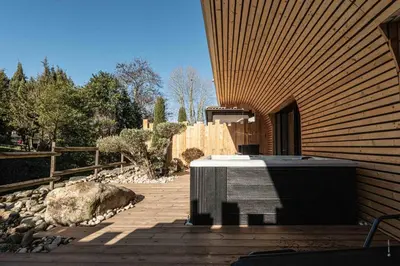 a backyard with a hot tub on a patio at Hôtel Le Parc - La Table de Franck Putelat in Carcassonne
