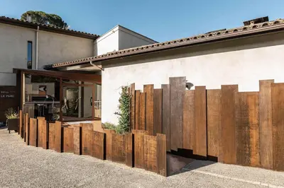 a wooden fence on the side of a building at Hôtel Le Parc - La Table de Franck Putelat in Carcassonne