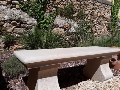 a stone bench sitting in the middle of a garden at L'écrin de l'Orb in Cessenon