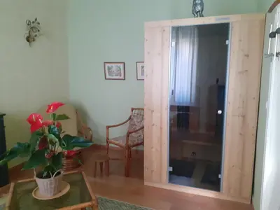 a room with a sliding glass door with a table at L'écrin de l'Orb in Cessenon