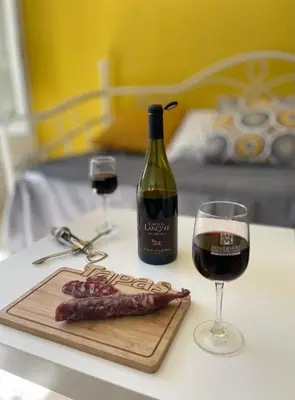 a bottle of wine and a glass of red wine at Au Perchoir in Caunes-Minervois