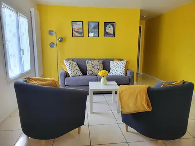 a living room with two blue couches and a table at Au Perchoir in Caunes-Minervois
