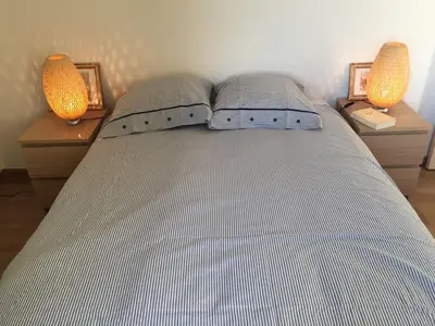 a bedroom with a bed with two lamps on two night stands at MAS DES VIGNES - View Cité de Carcassonne in Carcassonne