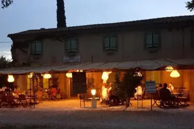 a building with people sitting outside of it at night at MAS DES VIGNES - View Cité de Carcassonne in Carcassonne