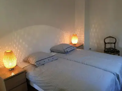 a bedroom with a bed with two lamps on it at MAS DES VIGNES - View Cité de Carcassonne in Carcassonne