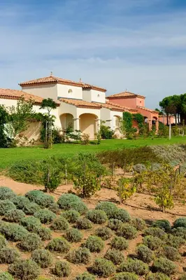 a house with a field of plants in front of it at Vacancéole - Port Minervois, Les Hauts du Lac in Homps