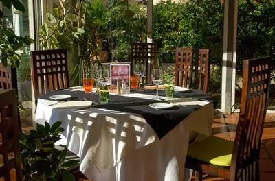 a table with a black and white table cloth on it at Hotel Le Phoebus Garden & Spa in Gruissan