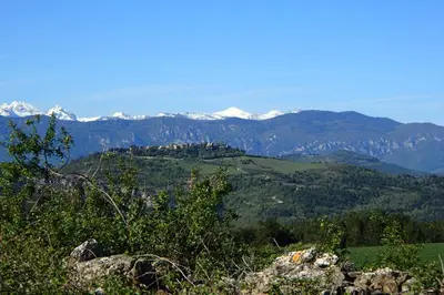 a view of a mountain range with snow covered mountains at La petite maison dans la prairie in Cassaignes