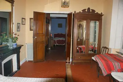 a living room with a room with a table and a room with a room at Maison du Parc in Saint-Chinian