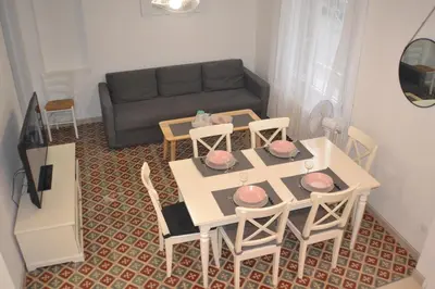 a living room with a table and chairs and a couch at La Bulle familles Clim, wifi, airport shuttle,tout à pied in Carcassonne