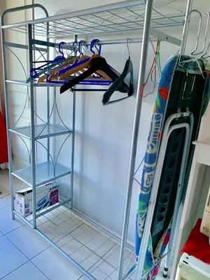a room with a rack with skis and a snowboard at La Meyssonnié in Damiatte