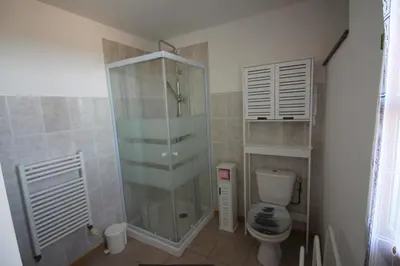 a bathroom with a sink and a washing machine at Le Jardin du Somail in Le Somail