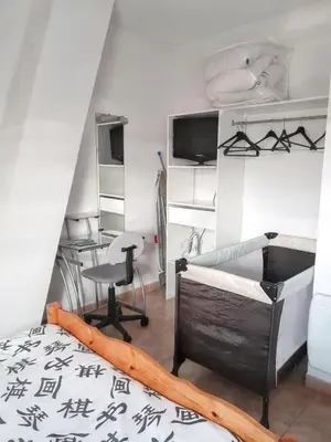 a room with a bed and a desk and a table at Maison accueillante à La Salvetat-sur-Agout avec terrasse in La Salvetat