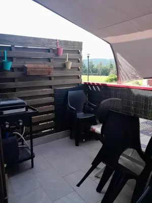 a room with two chairs and a piano on a patio at Maison accueillante à La Salvetat-sur-Agout avec terrasse in La Salvetat