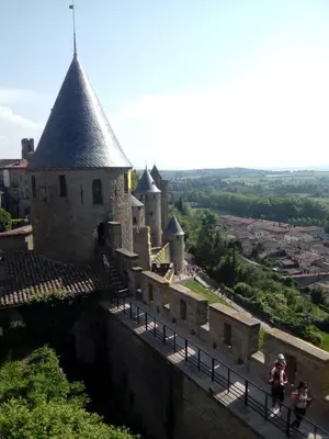 a group of tables and chairs sitting in front of a building at La Bastide 1 à 6 personnes en centre ville in Carcassonne