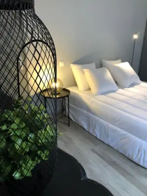 a bedroom with a bed and a basket next to a table at City'IN Appart in Carcassonne