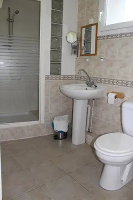 a bathroom with a sink and a toilet and a shower at Au Coeur de Rennes Gîte in Rennes-les-Bains