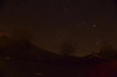 a starry sky at night with a house and trees at Les Divines Cascades in Roquefort-les-Cascades