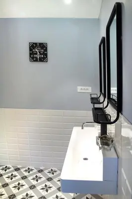a bathroom with a sink and a mirror at LA BOURDETTE in Saverdun