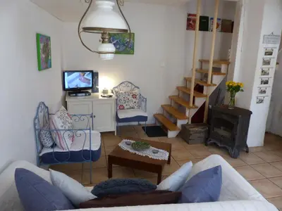a living room with a couch and a stove at Maison des Remparts nichée sous la Cité in Carcassonne