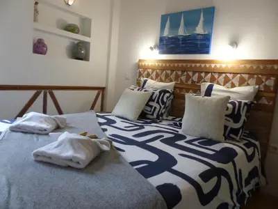 a bedroom with two beds with towels on them at Maison des Remparts nichée sous la Cité in Carcassonne