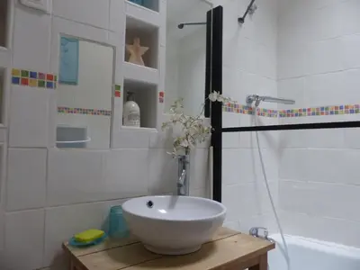 a bathroom with a bowl sink and a shower at Maison des Remparts nichée sous la Cité in Carcassonne