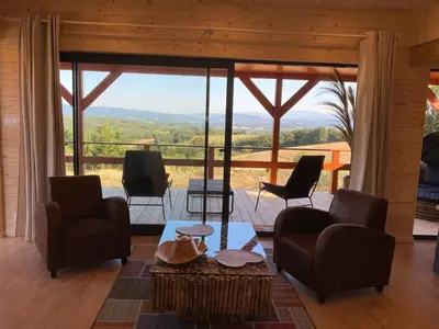 a living room with chairs and a table with a view at Cabanes Trésors de Campagne,spas privatifs in Villarzel-du-Razès
