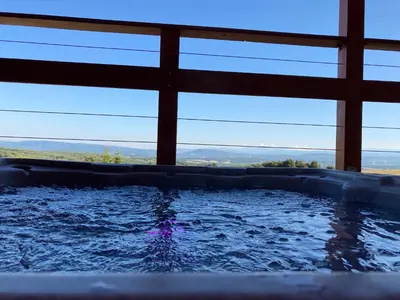 a hot tub in a house with a view at Cabanes Trésors de Campagne,spas privatifs in Villarzel-du-Razès