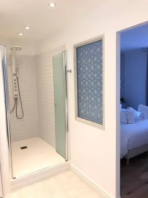 a bathroom with a shower with a glass door at Le Cœur de la Bastide - Adult only in Carcassonne