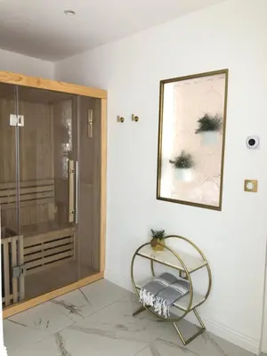 a room with a chair next to a glass door at Le Cœur de la Bastide - Adult only in Carcassonne