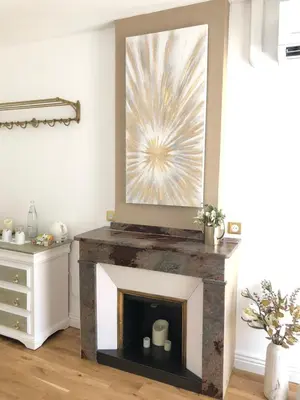 a living room with a fireplace with a painting at Le Cœur de la Bastide - Adult only in Carcassonne