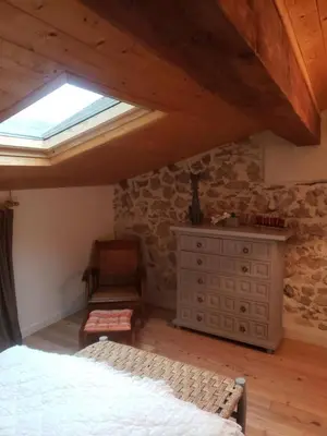 a bedroom with a bed and a skylight at Le Chateau in Camps-sur-lʼAgly