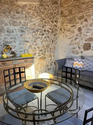 a room with a table and chairs and a couch at Le Chateau in Camps-sur-lʼAgly