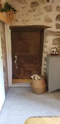 a room with a wooden door and a basket at Le Chateau in Camps-sur-lʼAgly