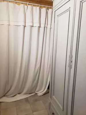 a white curtain next to a white cabinet at Le Chateau in Camps-sur-lʼAgly